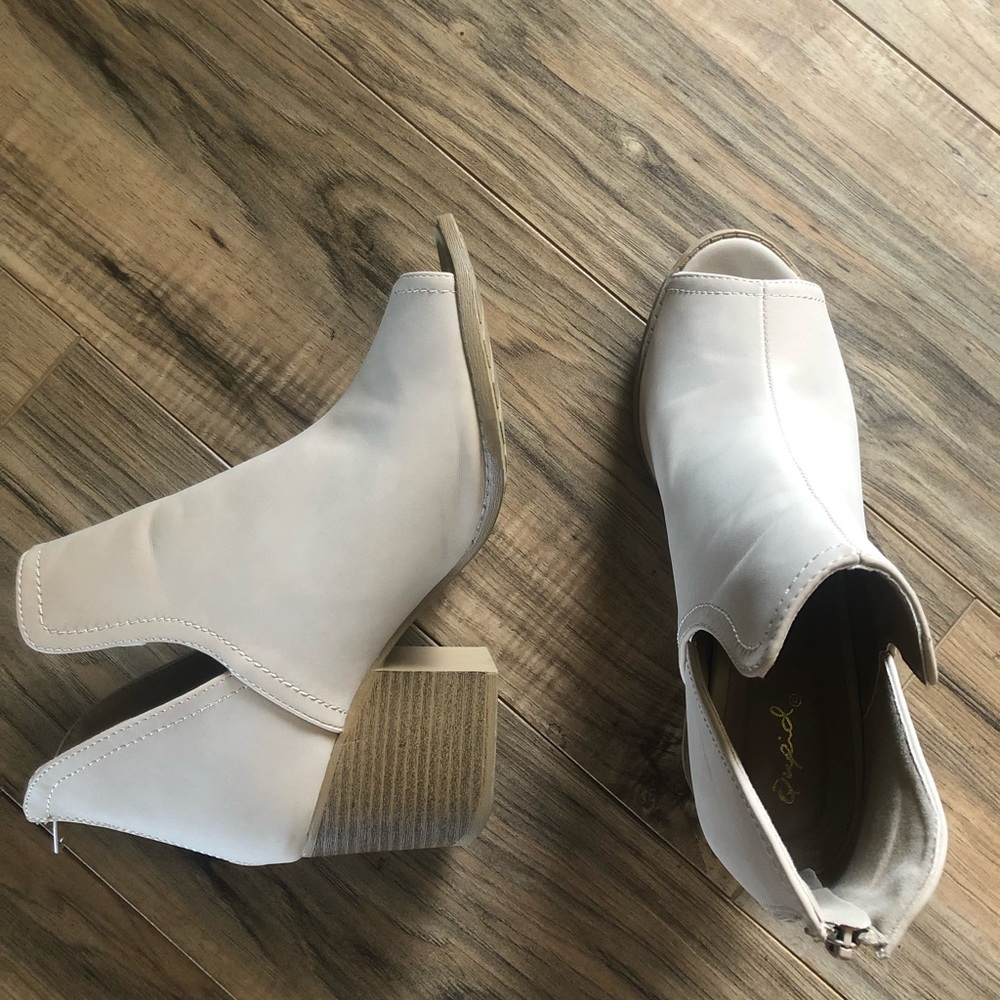 Cream colored open toe heeled booties